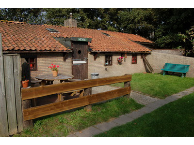 Henny Außenansicht mit Garten und Eingang zum Wohnbereich